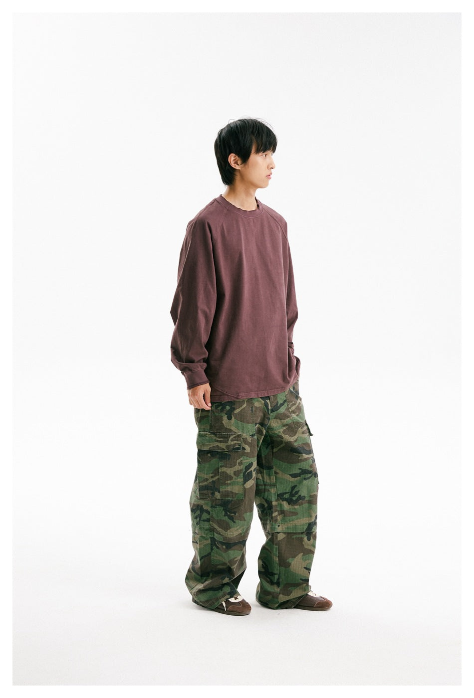 Model wearing an oversized muted burgundy long-sleeve raglan shirt, shown from the front at a slight angle.