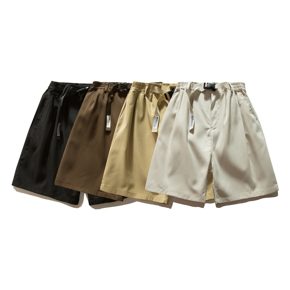 Several pairs of elastic-waist shorts with adjustable belts shown together in black, brown, tan, and cream.