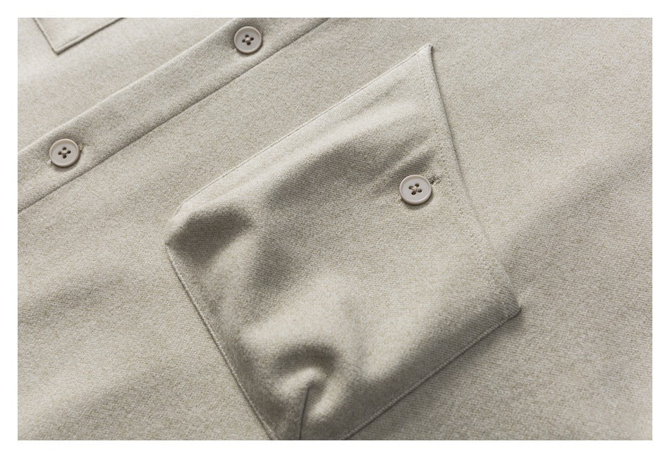 Close-up of a beige-gray shirt jacket’s button placket and large buttoned chest pocket.