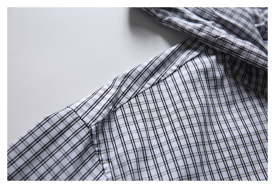 Close-up of the plaid shirt's shoulder seam and sleeve attachment.