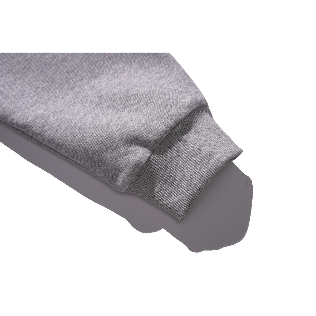 Close-up of a ribbed cuff on the gray sleeve of a hooded pullover.