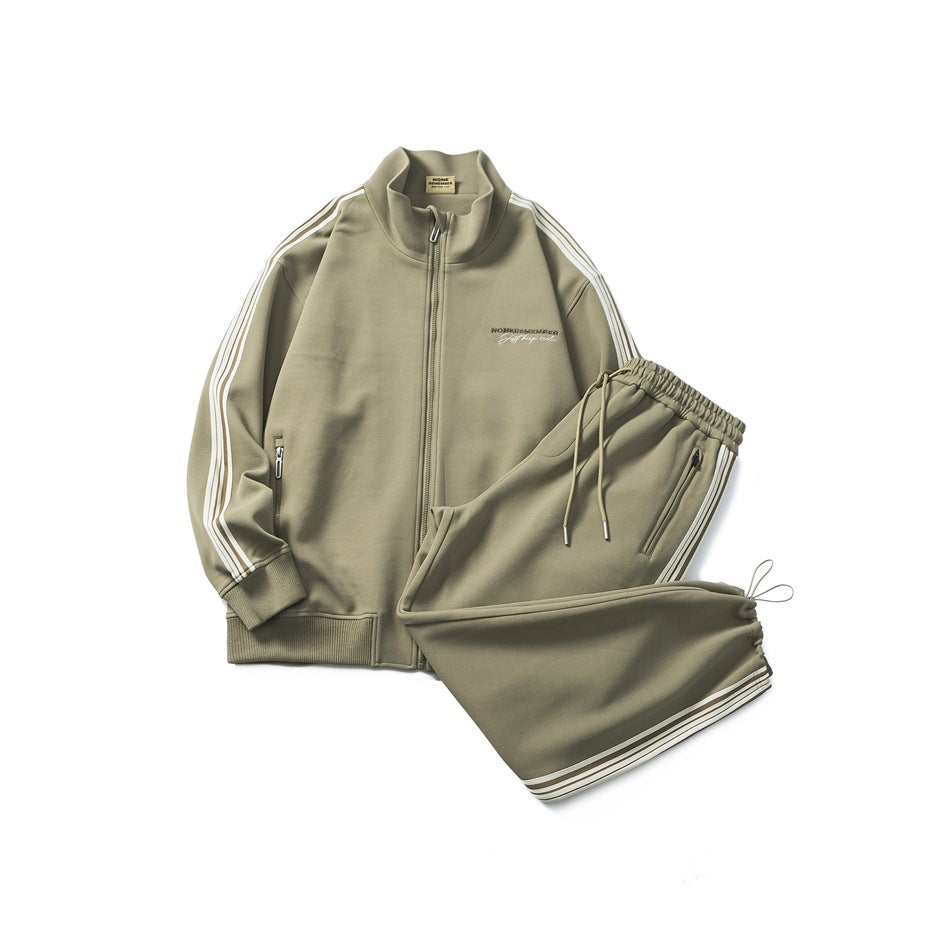 Olive-khaki striped track jacket and matching drawstring pants laid flat together as a set