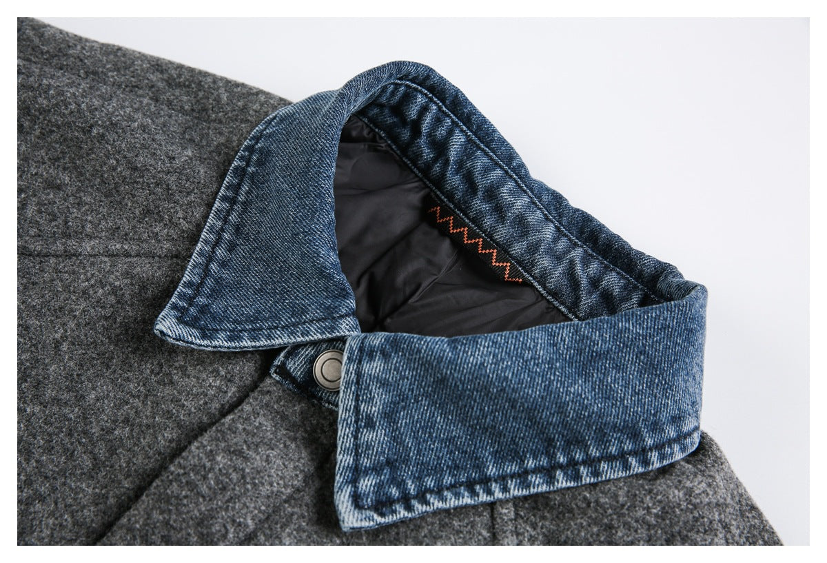 Close-up of the blue denim collar, dark lining, and snap fastening on a gray jacket.