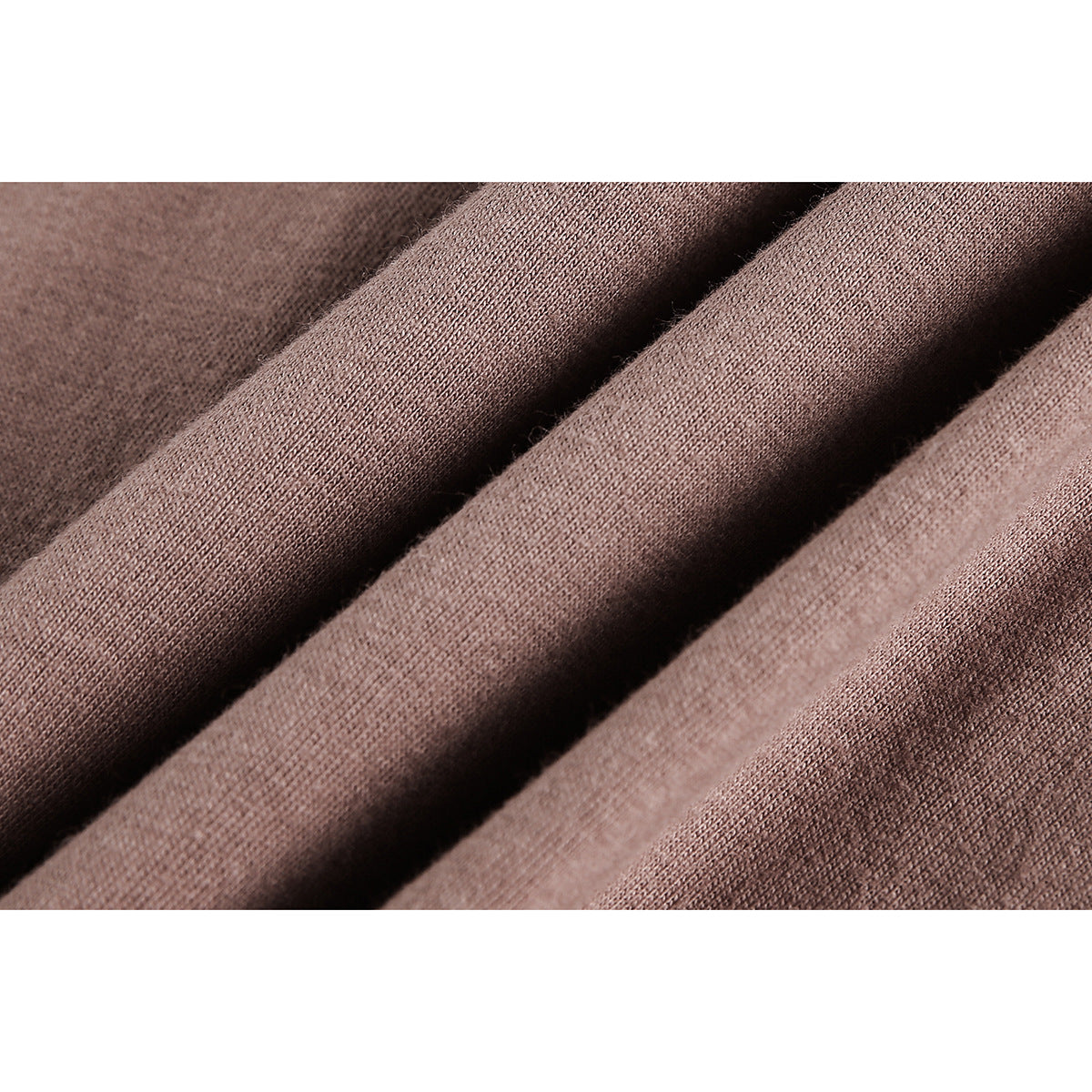 Macro view of brown knit fabric gathered into soft folds.