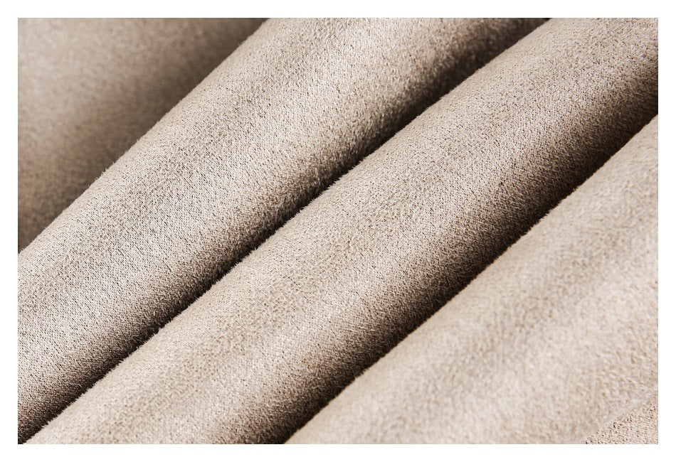 Close-up of folded beige fabric showing its textured surface.