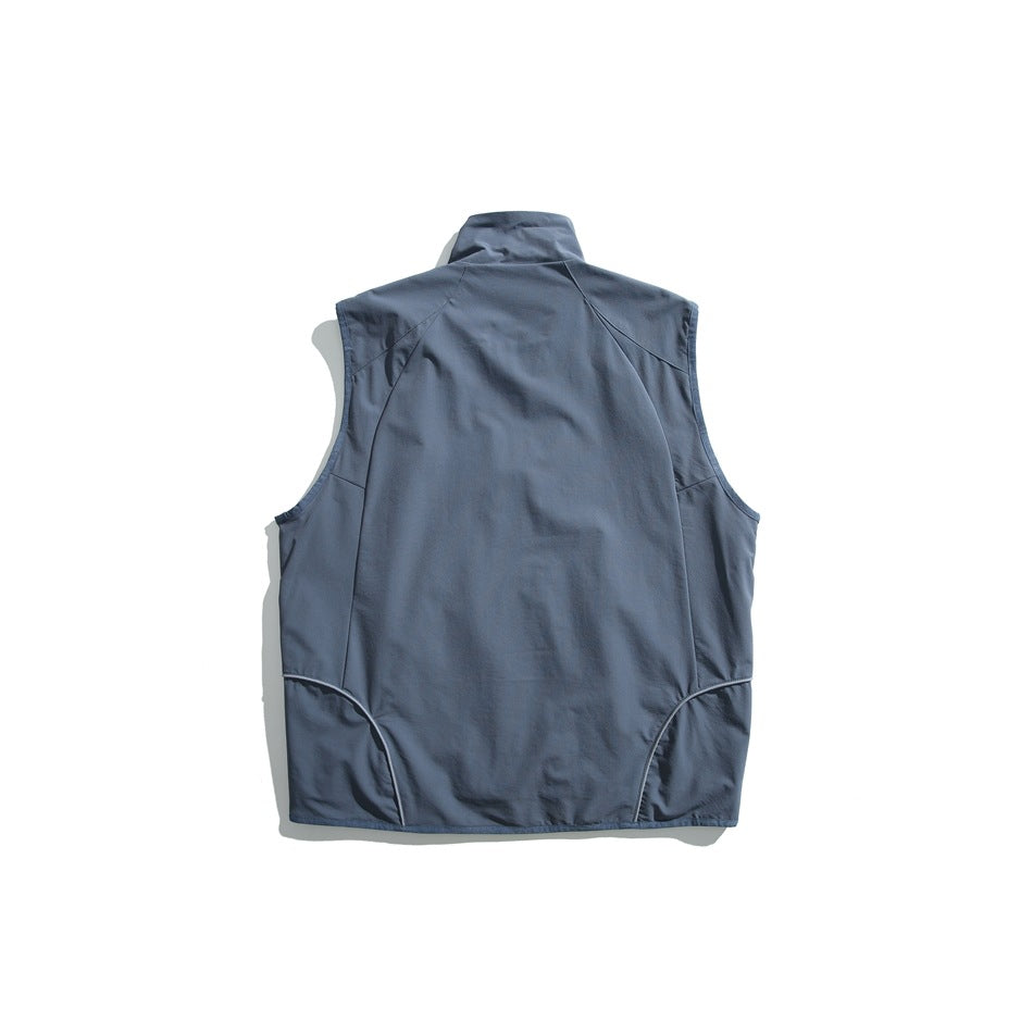 Back view of a slate-blue sleeveless vest with a stand collar and curved lower seams.