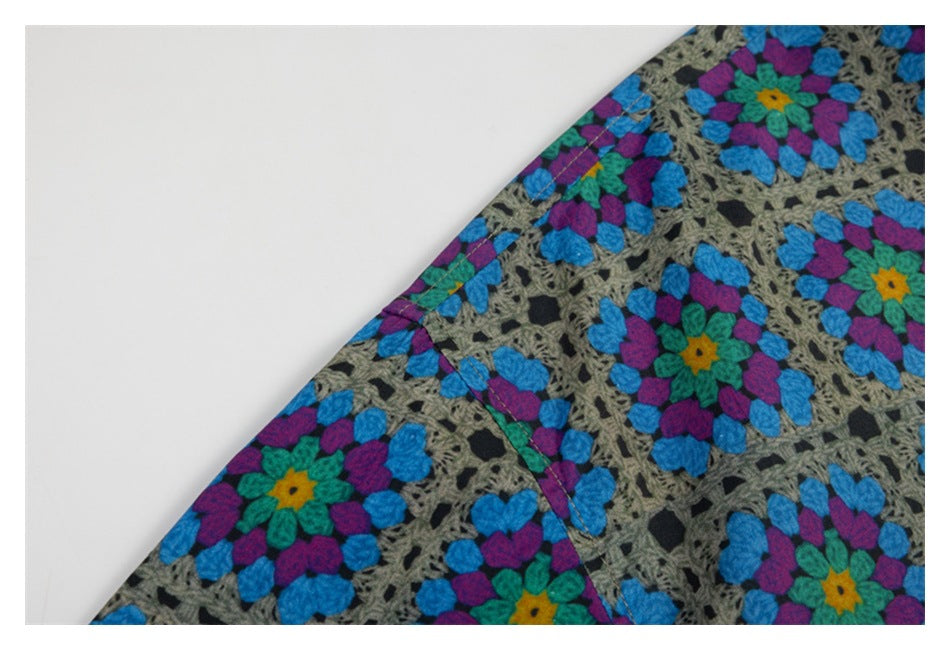 Close-up of a stitched seam on the colorful floral geometric shirt.