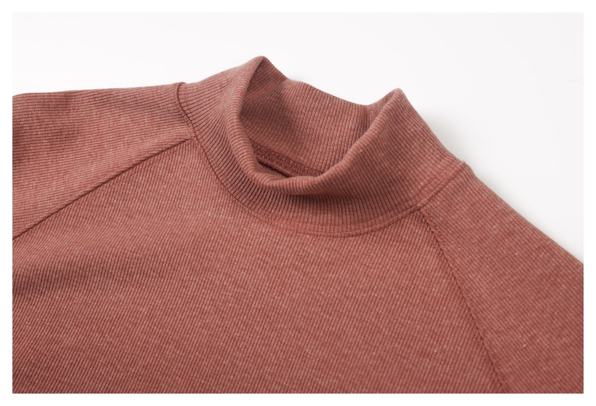 Close-up of the dusty rose ribbed top's high collar and raglan shoulder seams.