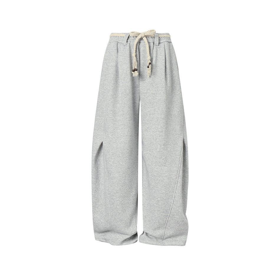 Heather gray wide-leg sweatpants, front view, with braided cream rope tied in a bow at the waist and curved leg seams