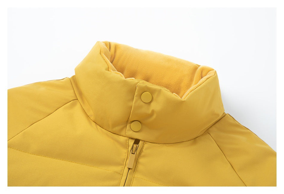 Close-up of a mustard-yellow jacket collar showing two snaps, soft inner lining, and the top of the zipper.