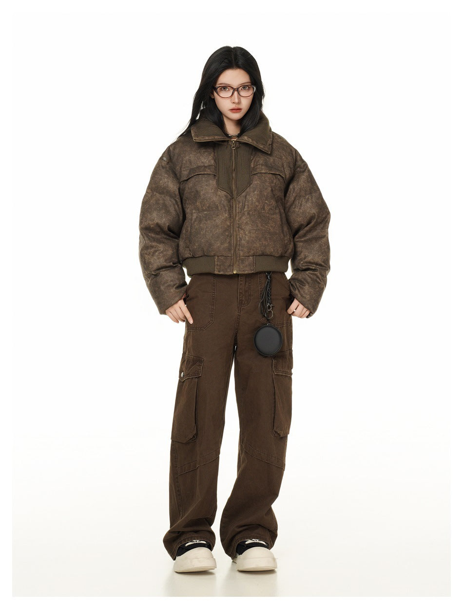Full-length view of a model in the cropped brown puffer jacket, brown cargo pants and white-soled shoes