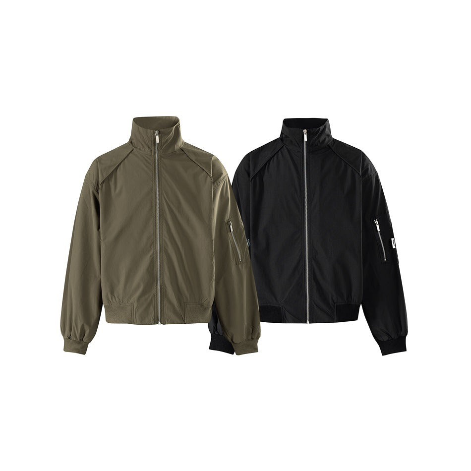 Front view of two high-collar zip jackets, one olive and one black, with ribbed cuffs and hems.