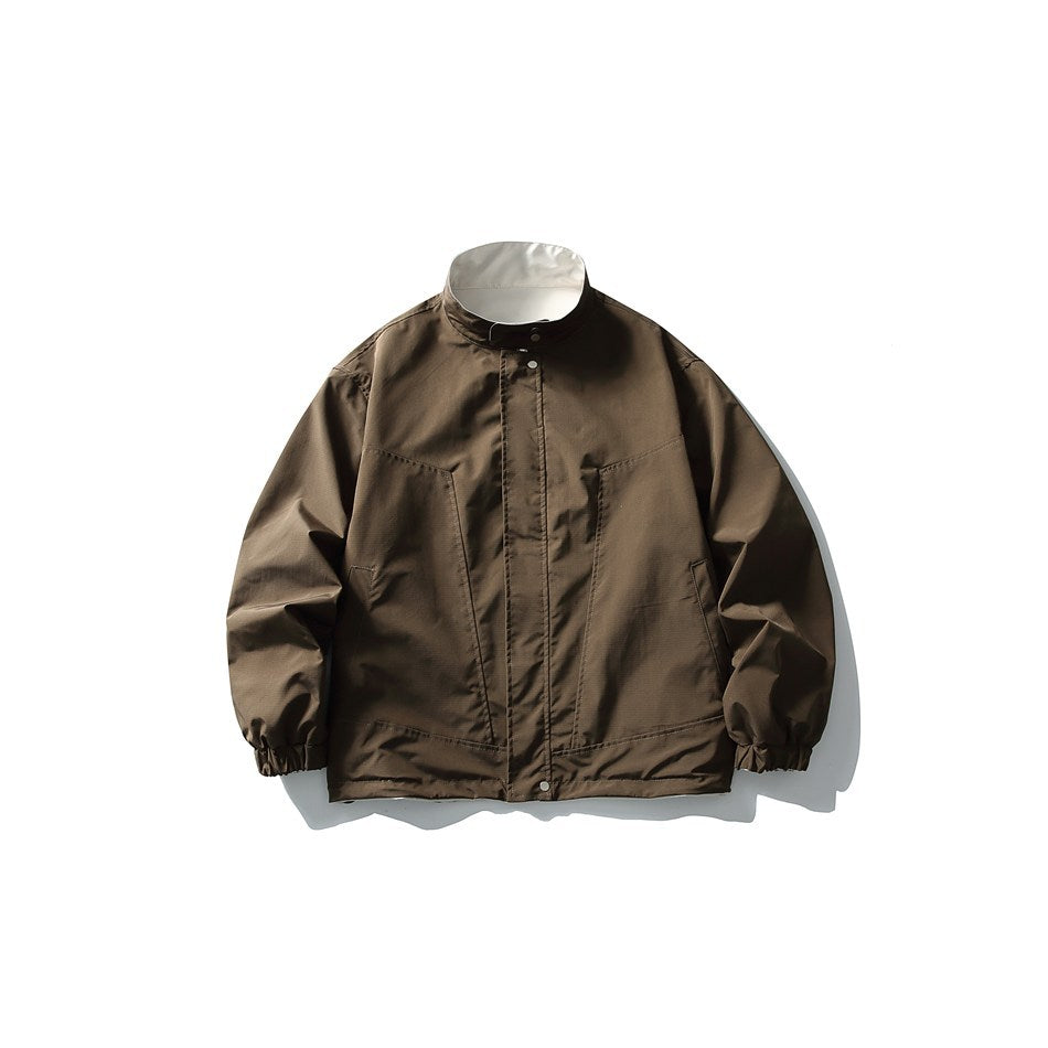 Brown stand-collar jacket flat lay, front view, with off-white inner collar, stitched panels and elastic cuffs