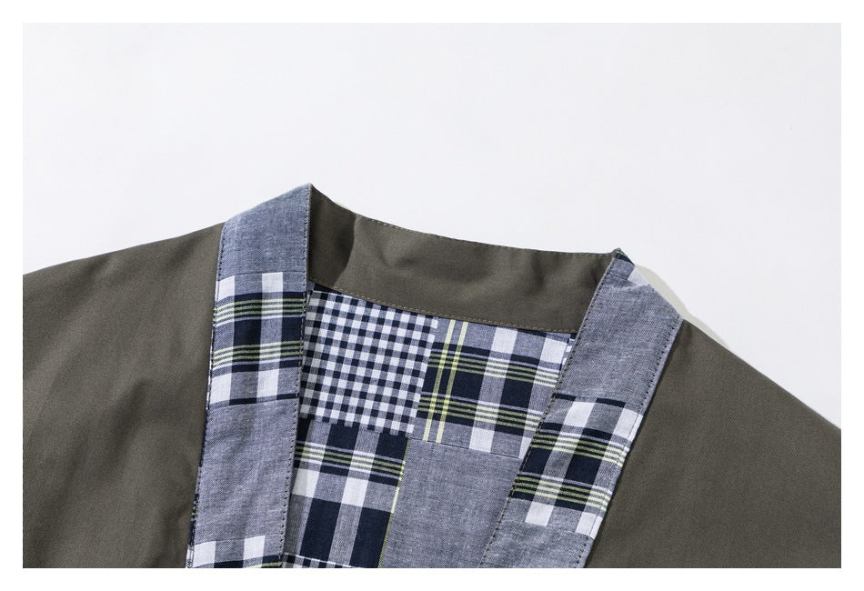 Close-up of the jacket's olive neckline and plaid inner panel and front trim.