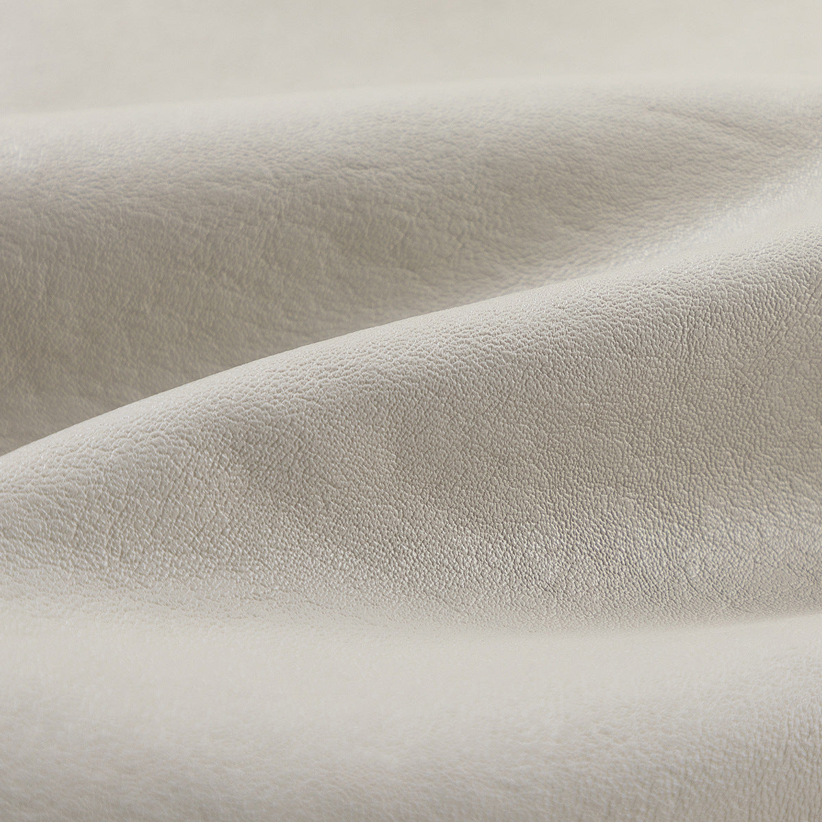 Close-up showing the lightly pebbled surface of ivory jacket material.