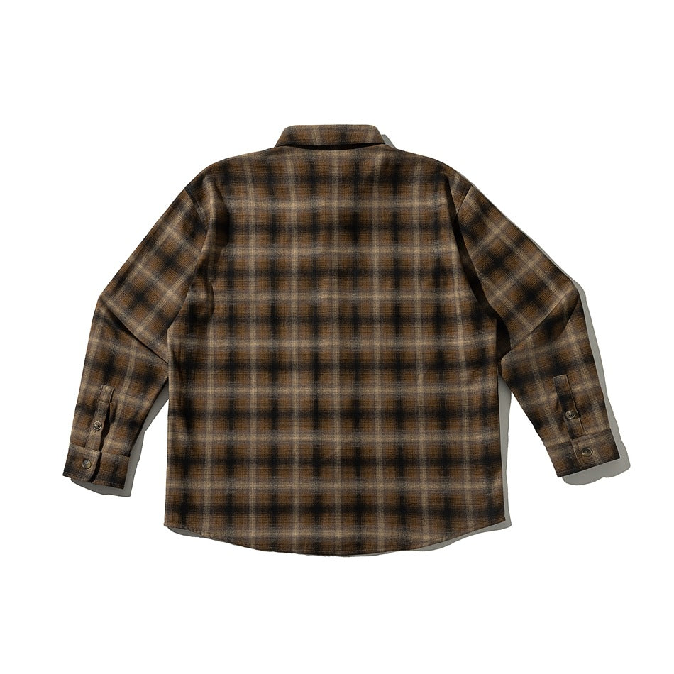 Back view of a brown and black plaid button-up shirt with long sleeves and button cuffs.