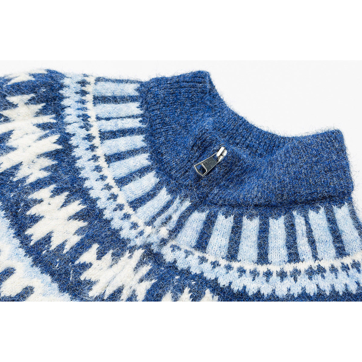 Close-up of a blue-and-white patterned knit sweater's stand collar and metal zipper pull.