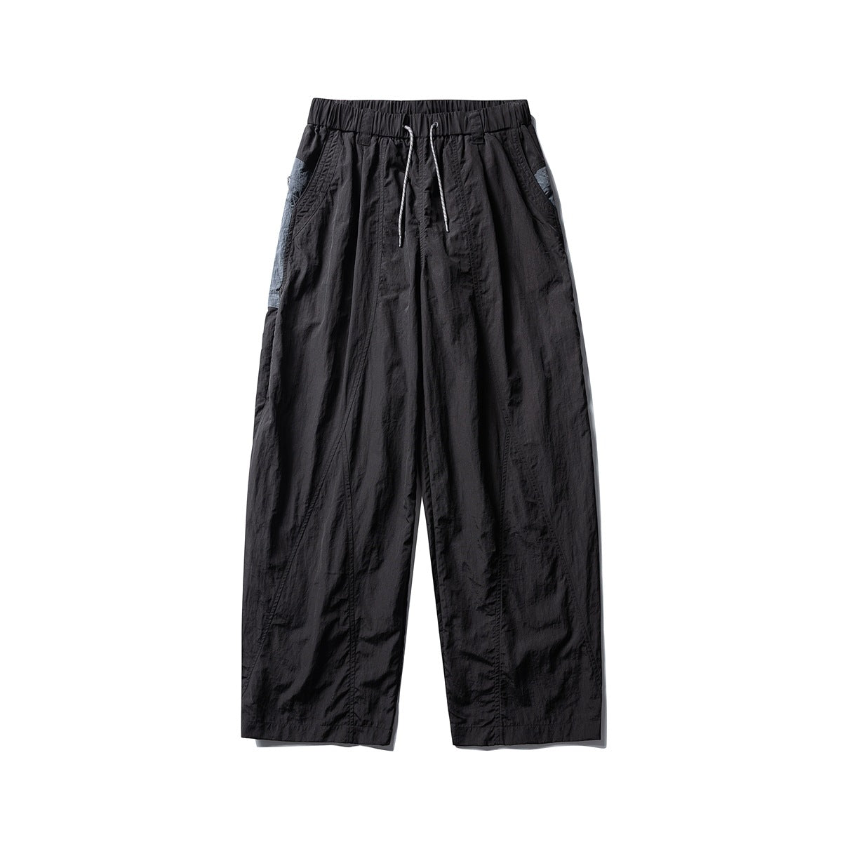 Black wide-leg drawstring pants with elastic waist and gray-blue contrast panels at the side pockets, flat lay front view