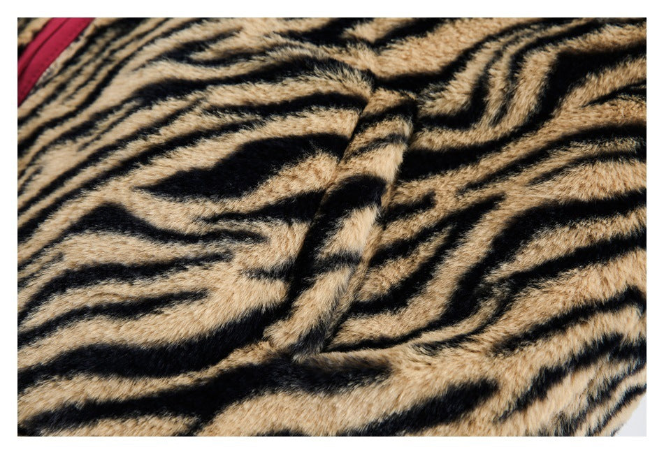 Close-up of a seam on the tan-and-black tiger-striped plush garment.