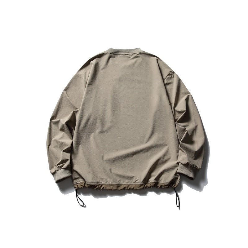 Back view of a plain taupe pullover with long sleeves, ribbed cuffs and adjustable drawcords at the hem.
