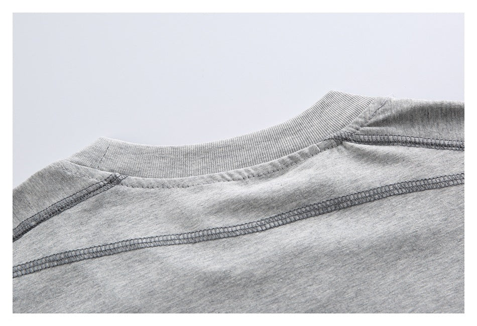 Close-up of the back neckline and shoulder seams of a heather-gray shirt.
