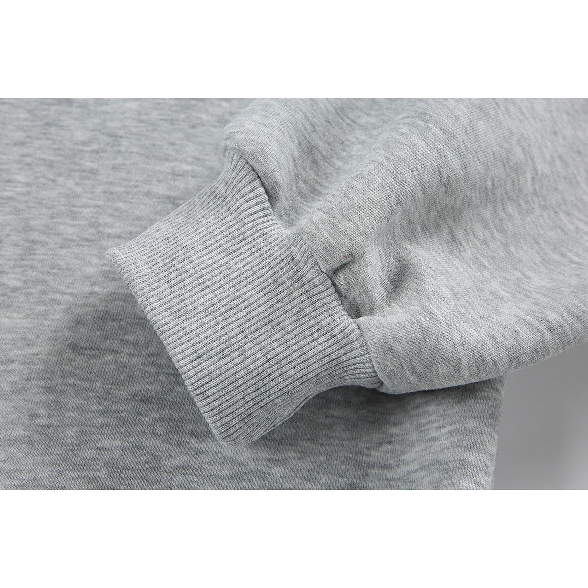 Close-up of a heather-gray sweatshirt sleeve and ribbed cuff.