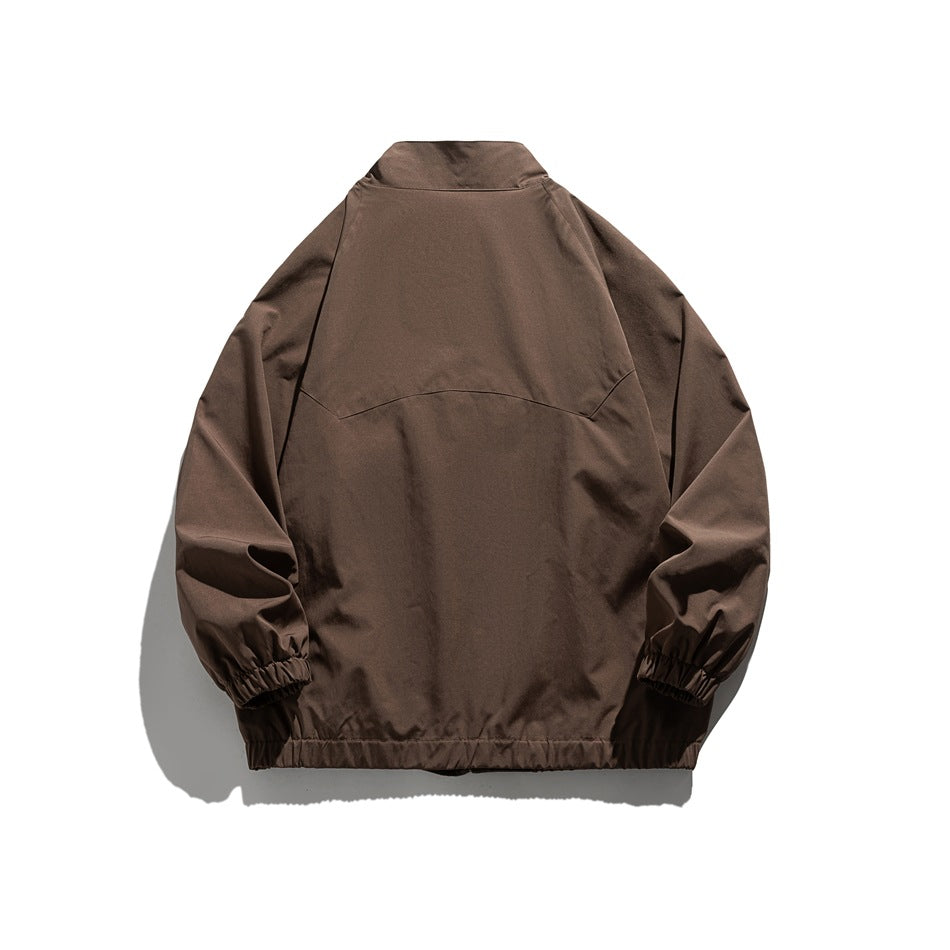 Back view of a brown jacket with a stand collar, panel seams, elastic cuffs, and hem.
