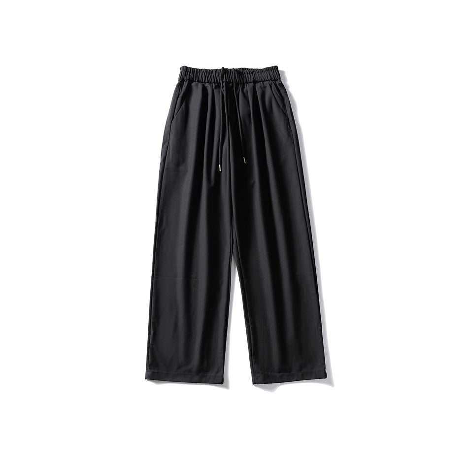 Black wide-leg drawstring elastic-waist trousers laid flat, front view with side pockets