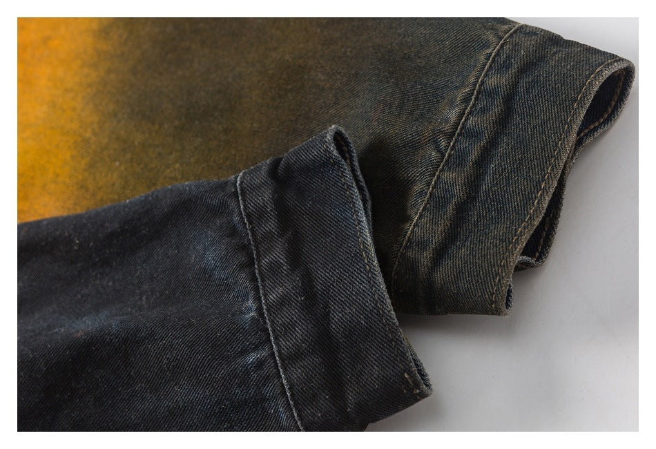 Close-up of two folded denim sleeve cuffs in dark charcoal and olive-brown washes.