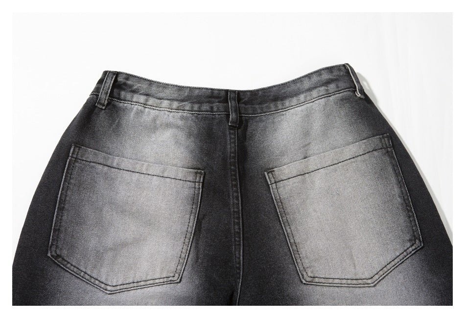 Flat-lay rear view of black-gray jeans with two patch pockets, belt loops and faded denim.