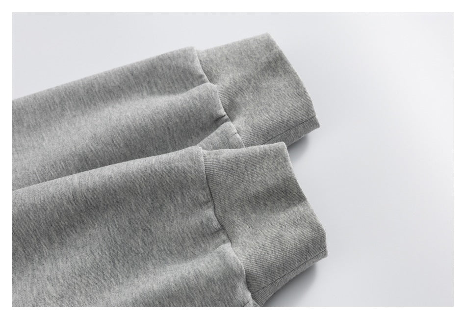 Close-up of two gray ribbed sleeve cuffs laid flat against a white background.