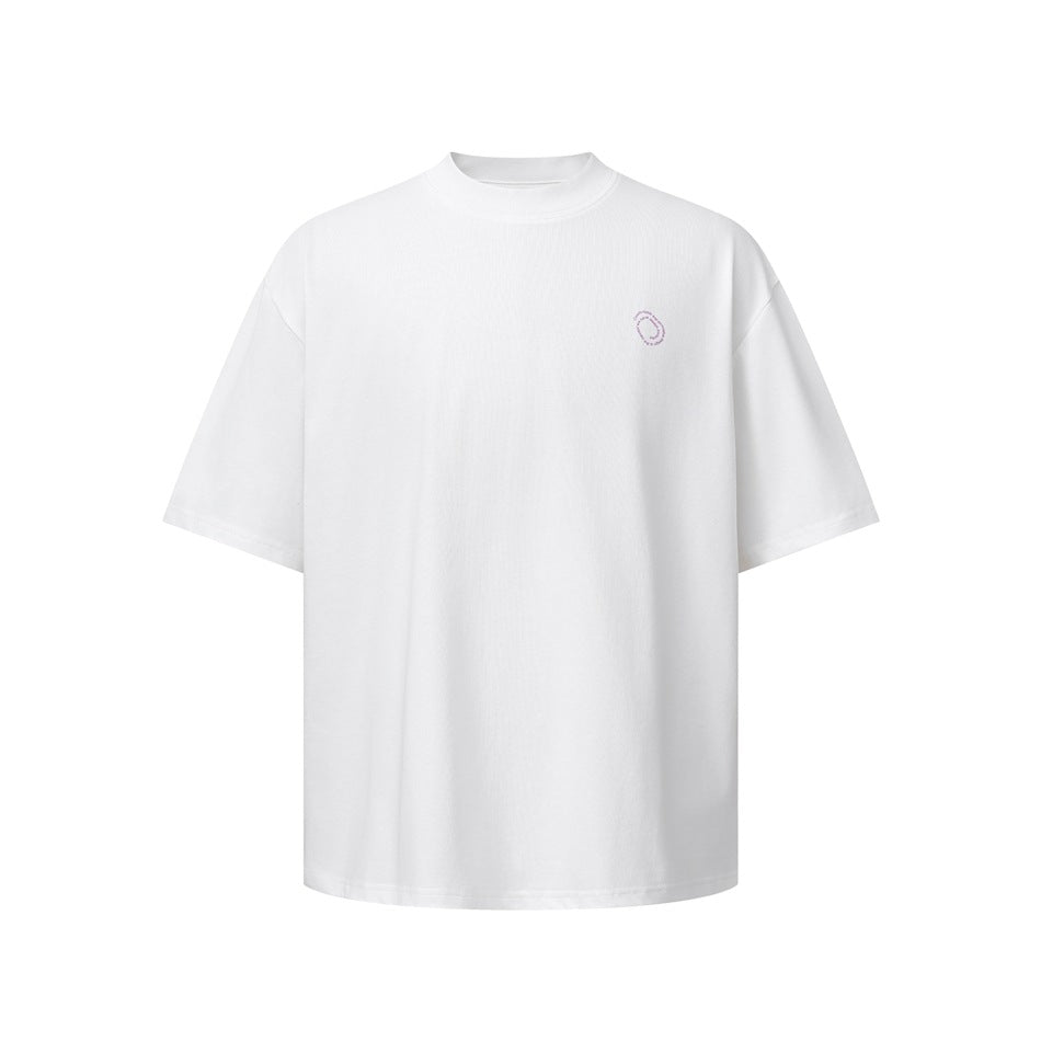 Front view of a white oversized crew-neck T-shirt with a small pale pink circular chest emblem.