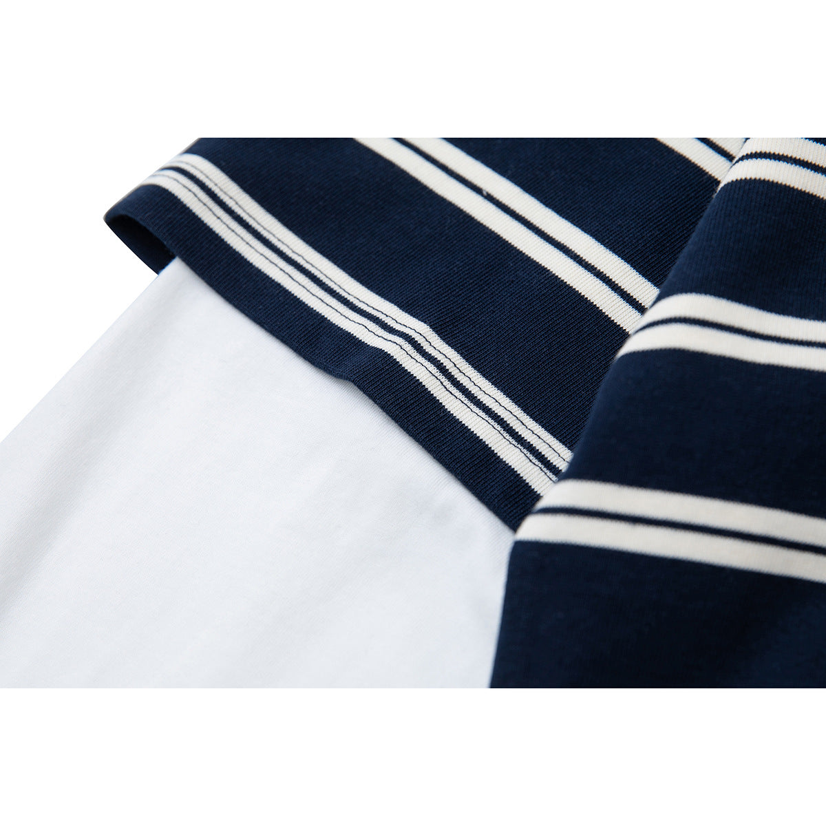Close-up of a navy-and-white striped sleeve cuff beside the plain white sleeve fabric.