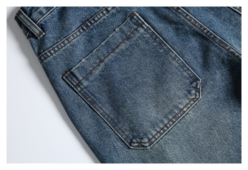Close-up of a rear pocket on faded blue jeans with contrast stitching and a belt loop nearby.