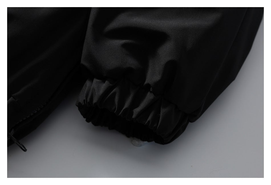 Close-up of the black jacket's gathered elastic sleeve cuff.