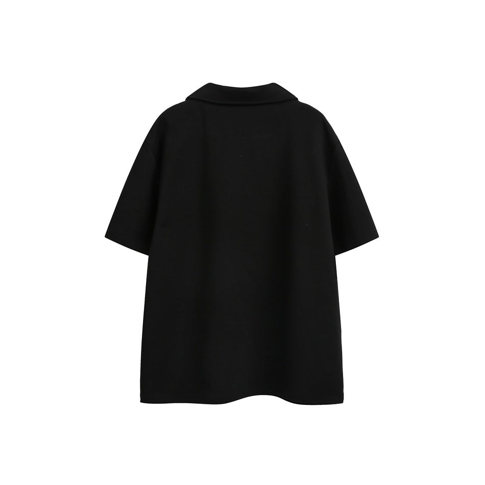 Back view of a plain black short-sleeve polo shirt with a broad collar, displayed against a white background.