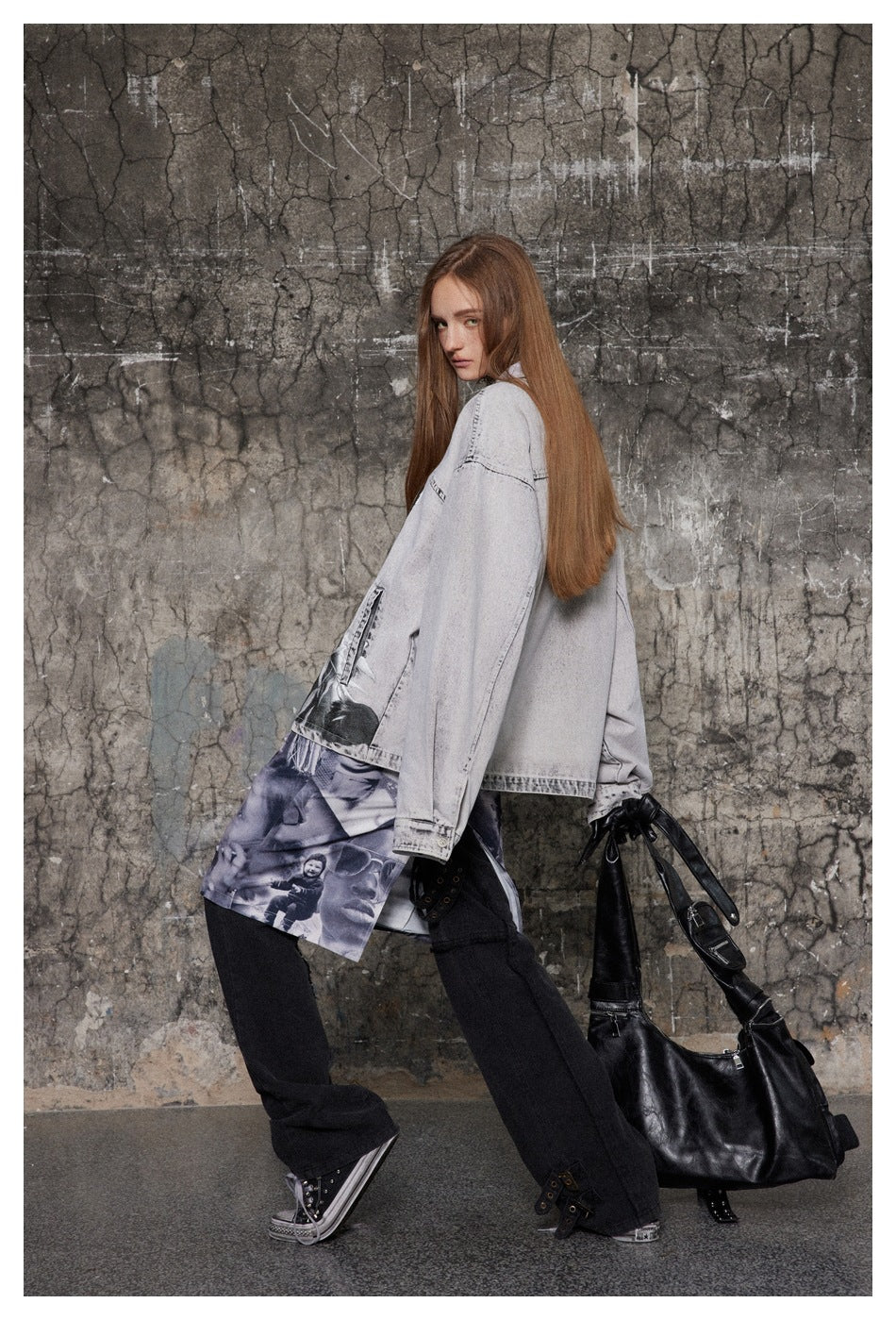 Model in a light gray oversized jacket with photo prints, a graphic skirt, and black trousers, shown in side view.