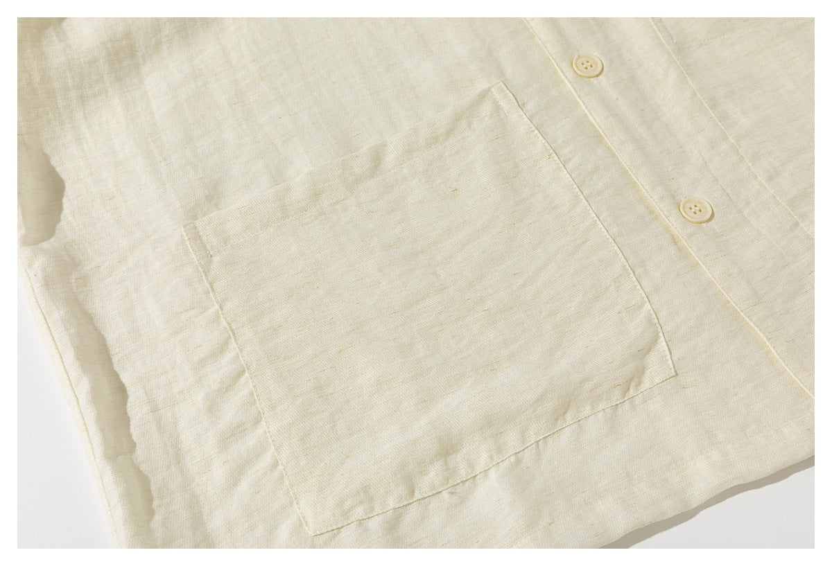 Close-up showing a large patch pocket and buttons on the cream shirt.