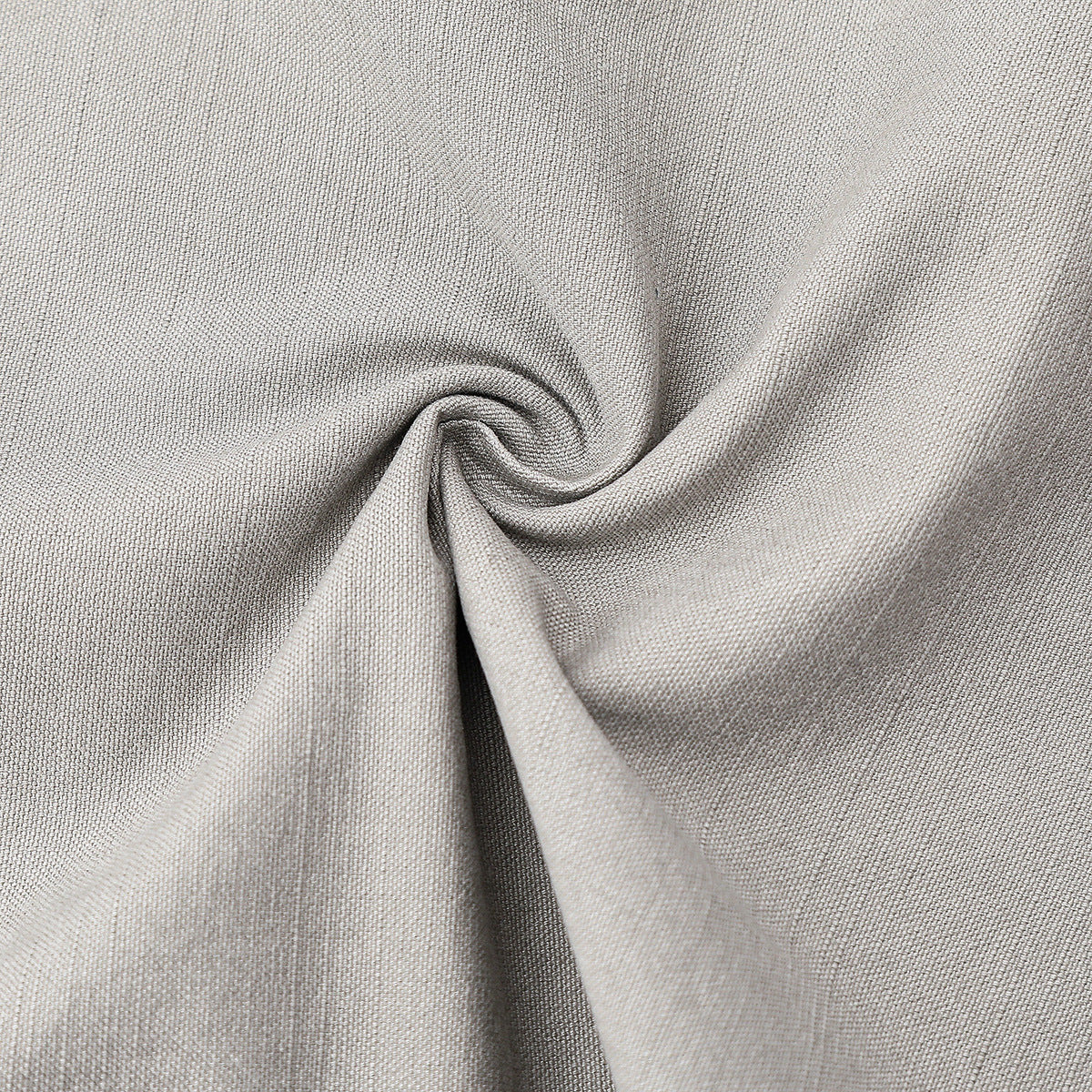 Close-up of light gray woven fabric gathered into a swirl, showing its surface texture.