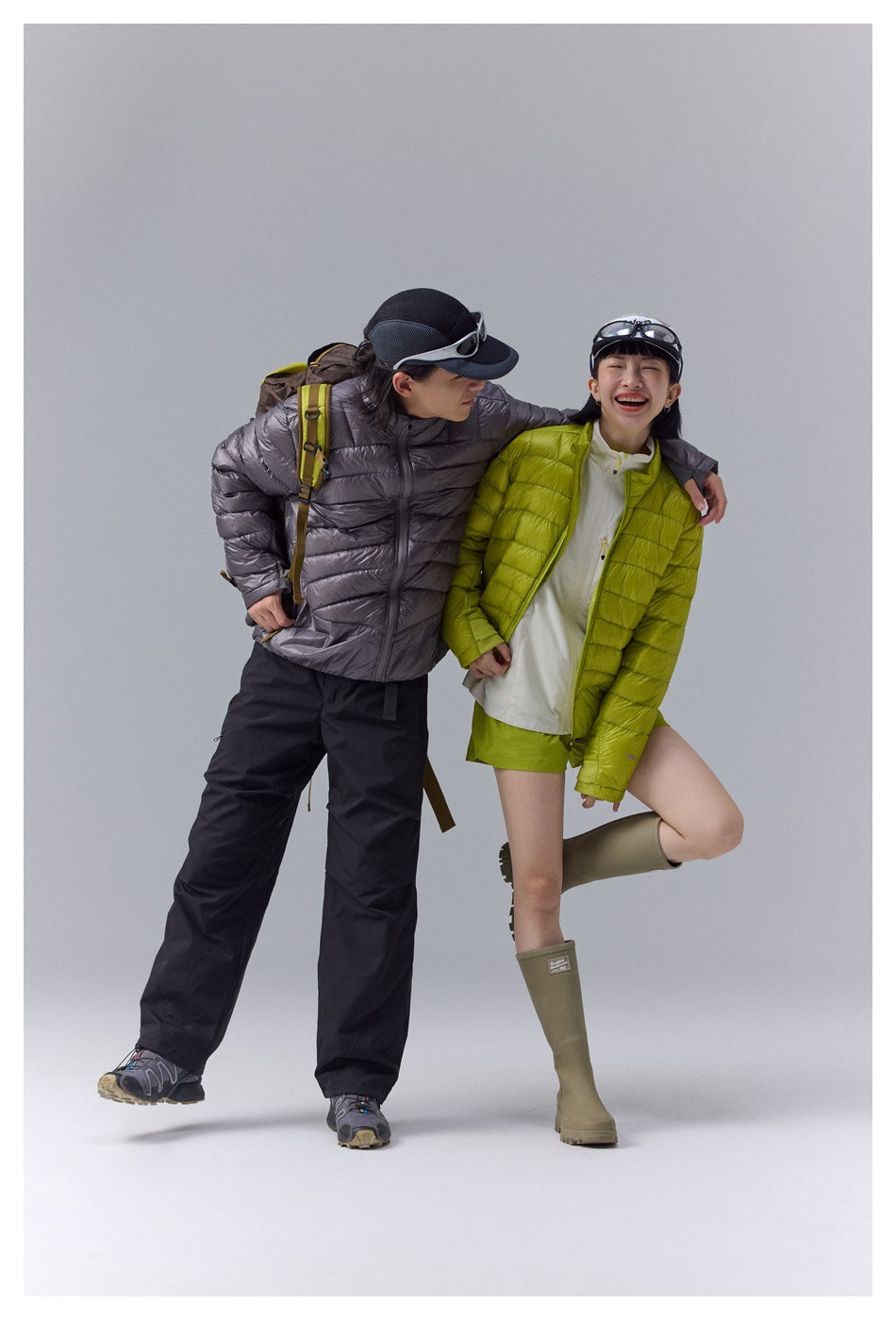 Two models wear quilted jackets in charcoal gray and bright lime green.