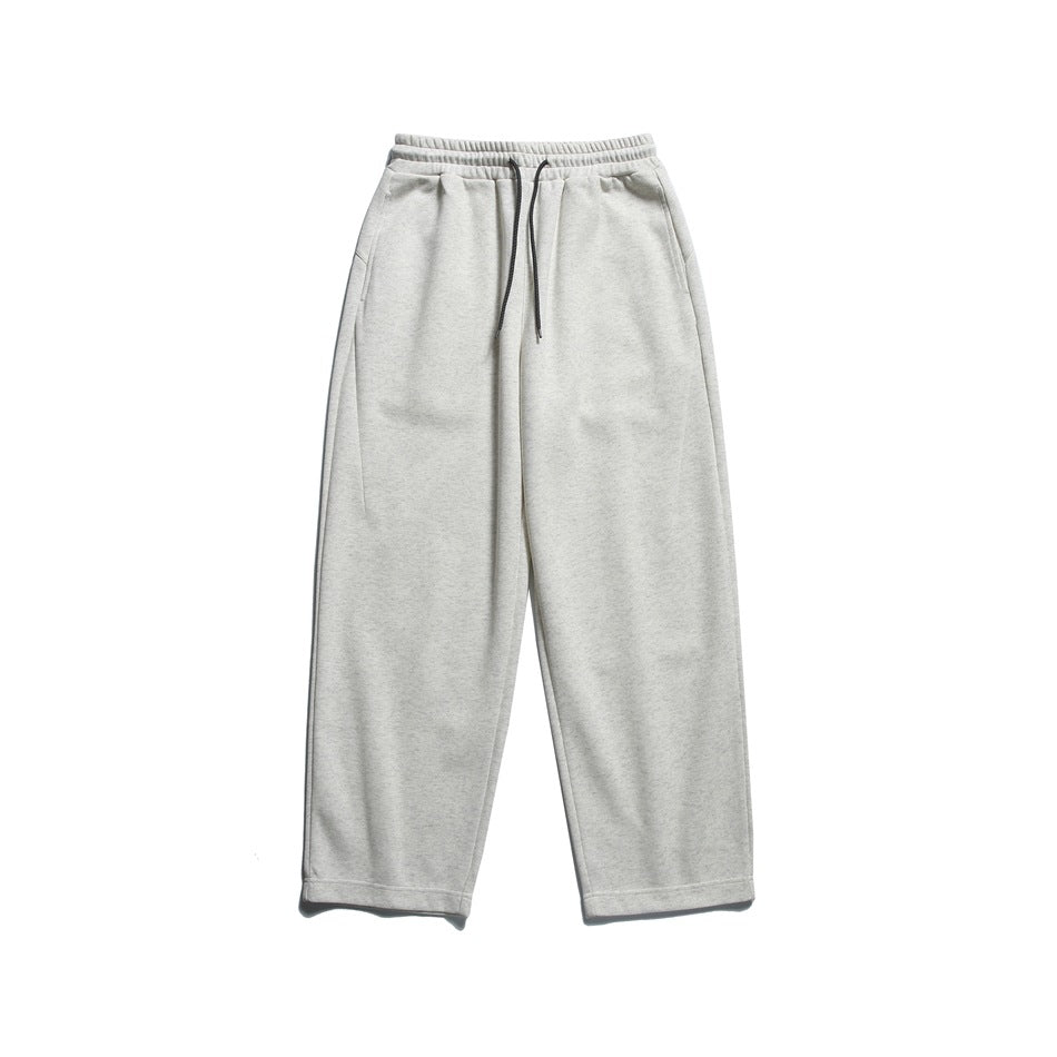 Light heathered off-white drawstring sweatpants with wide straight legs, laid flat, front view