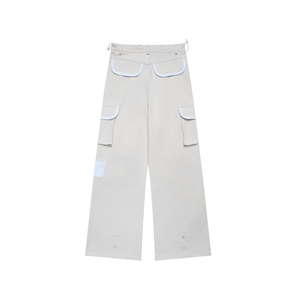 Back view of light gray wide-leg cargo pants with pale-trimmed pockets and snap details at the hems.