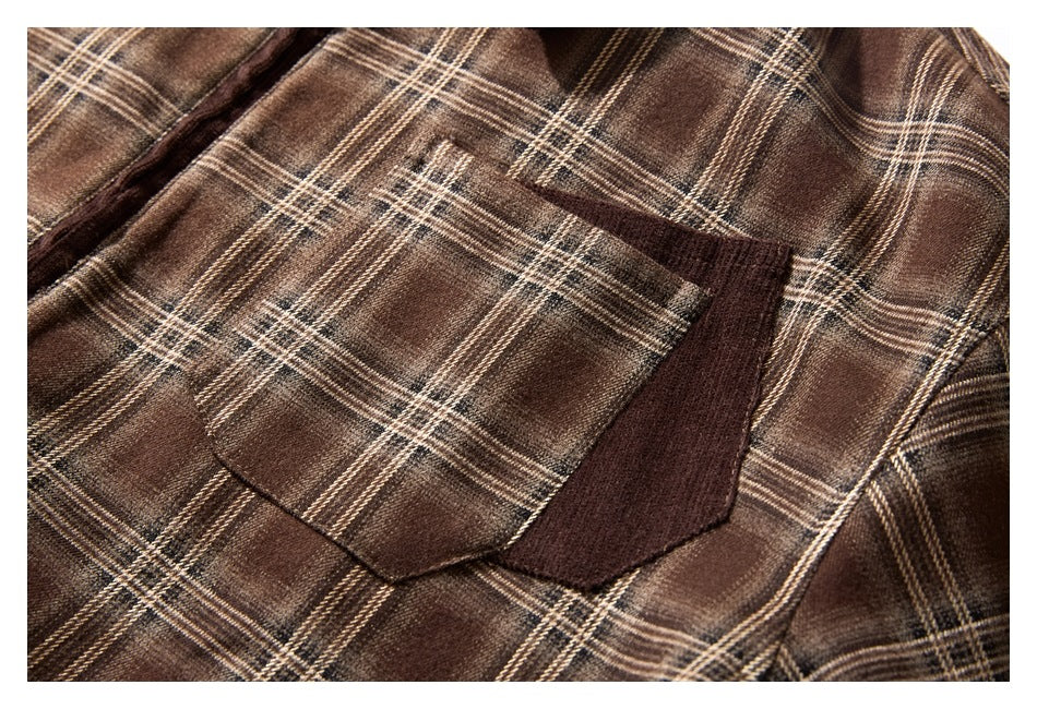 Close-up of a brown plaid garment with a large patch pocket and dark brown trim.