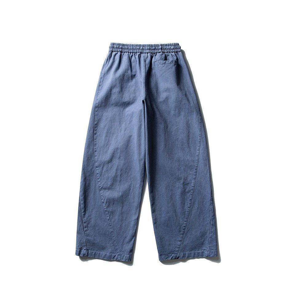 Blue wide-leg pants back view with elastic waistband, curved seams and a back welt pocket