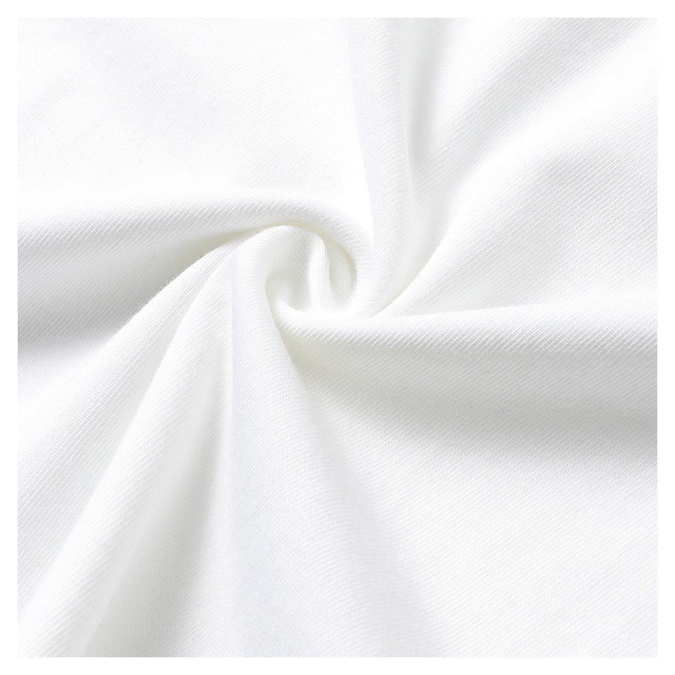 Close-up of white fabric gathered into a swirl, showing its fine surface texture.