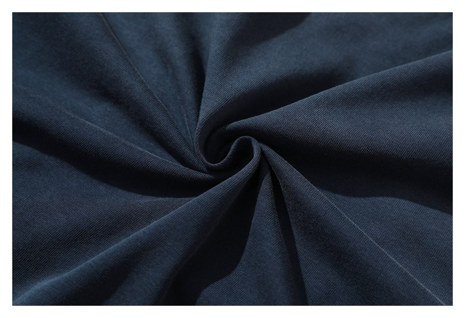 Dark navy fabric gathered into a swirl, showing its surface and drape.