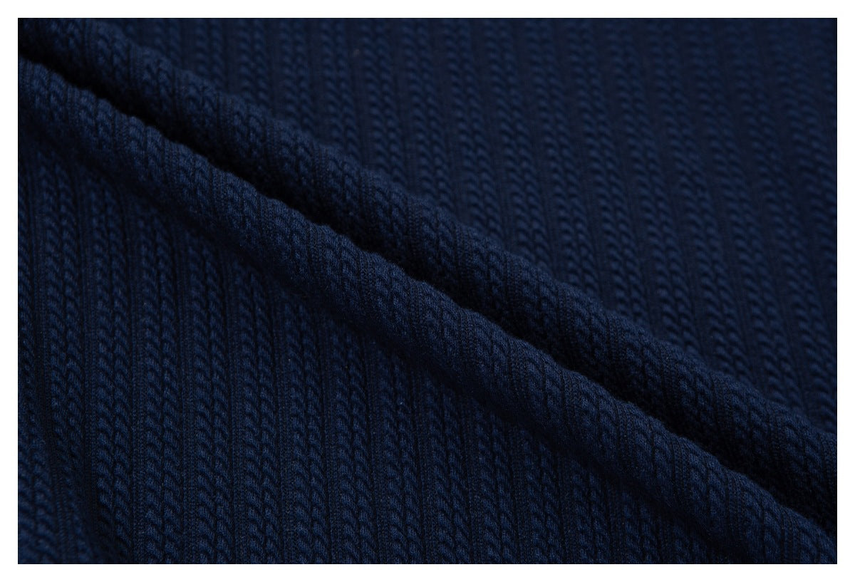 Close-up showing the raised vertical rib texture of navy fabric folded diagonally.