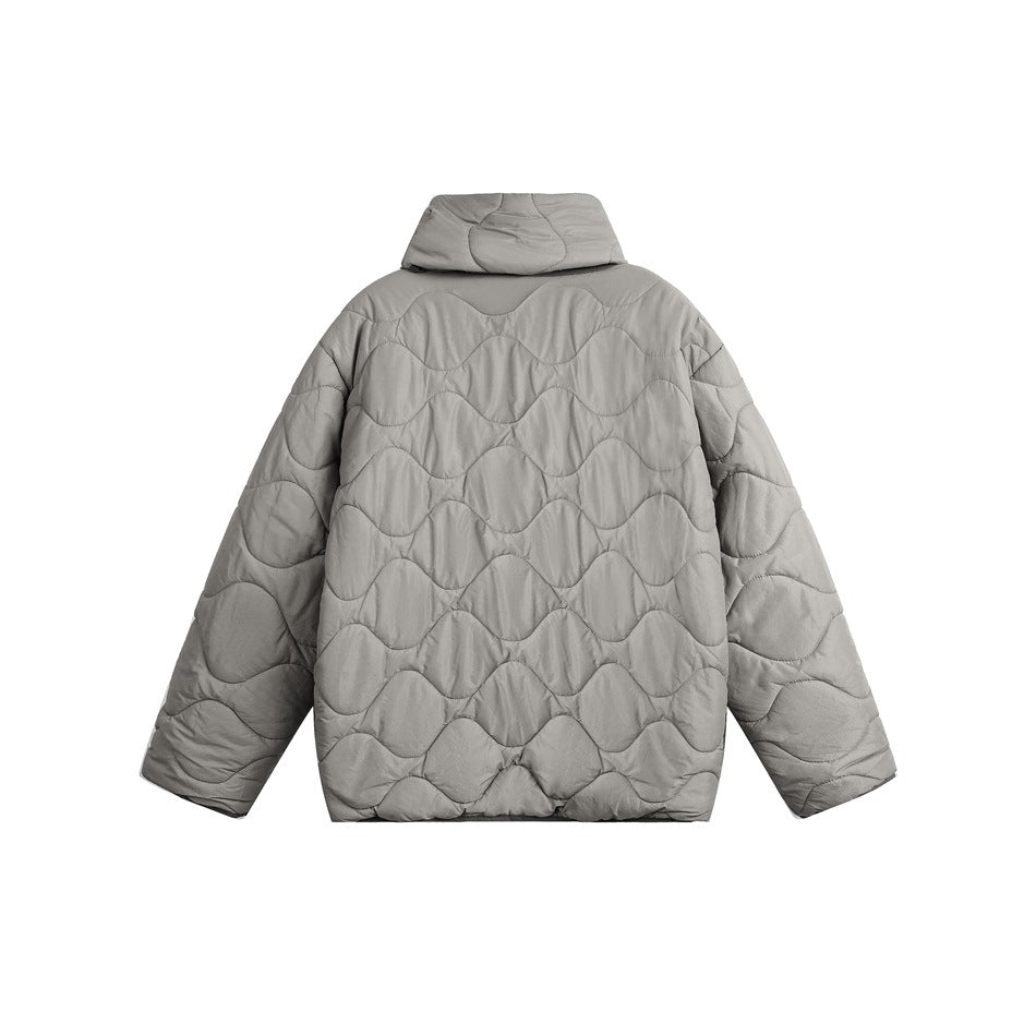 Back view of a light gray quilted jacket with a raised collar and wavy stitched panels.