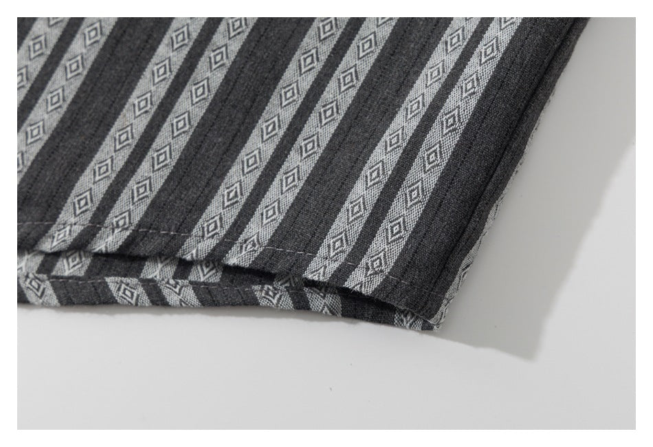 Close-up of the shirt's striped bottom hem and stitched edge.