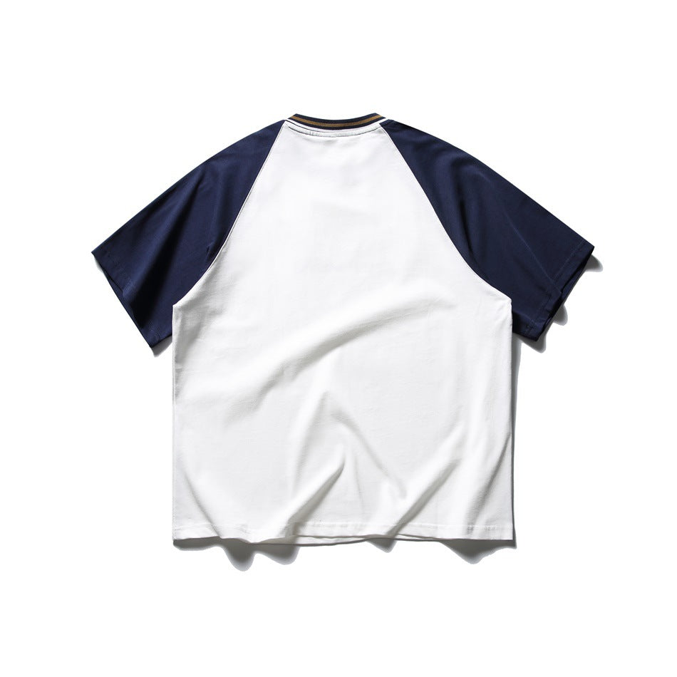 Back view of white T-shirt with navy raglan sleeves and striped ribbed collar, flat lay